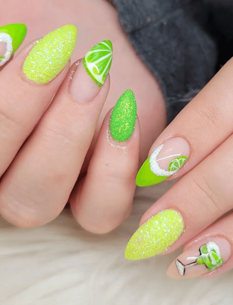 A set of nails with a lime green theme, including glittery textures and a margarita glass design, celebrating Cinco de Mayo.