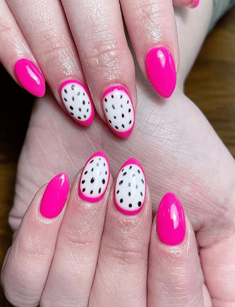 Bright pink nails with alternating dragon fruit nail designs, featuring white bases with black seeds on the accent nails.