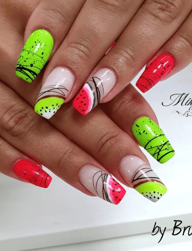 Nail art with vibrant kiwi and watermelon fruit designs, featuring neon green and speckled red patterns on a semi-transparent base.
