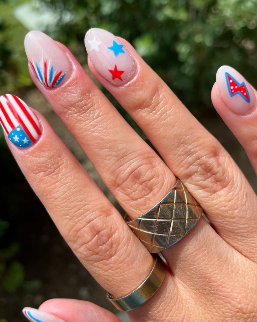 4th of July nails featuring detailed US flag and stars with fireworks splash