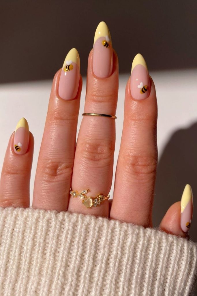 Summer nails designs featuring Yellow French tips with bees