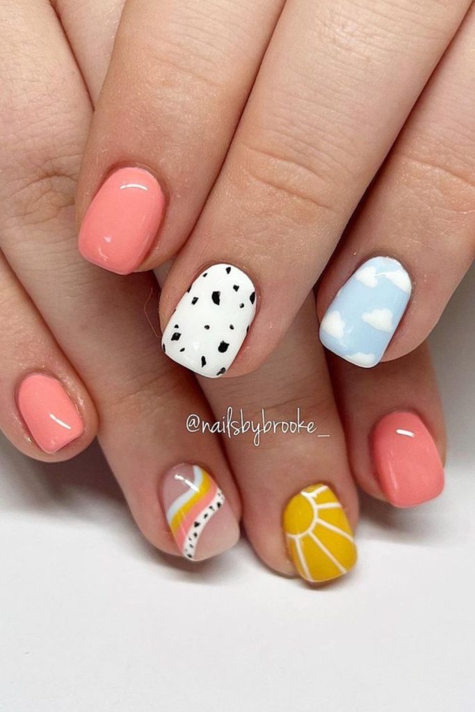short summer nails featuring speckled, cloud and sun nail arts